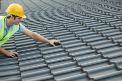 Builder Working On Roof Of New Building