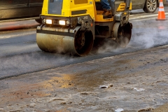 Urban road is under construction, asphalting of yellow roller